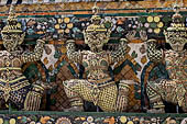 Bangkok Wat Arun - the statues of the mythical  demon bears  that support the different levels of the prang.